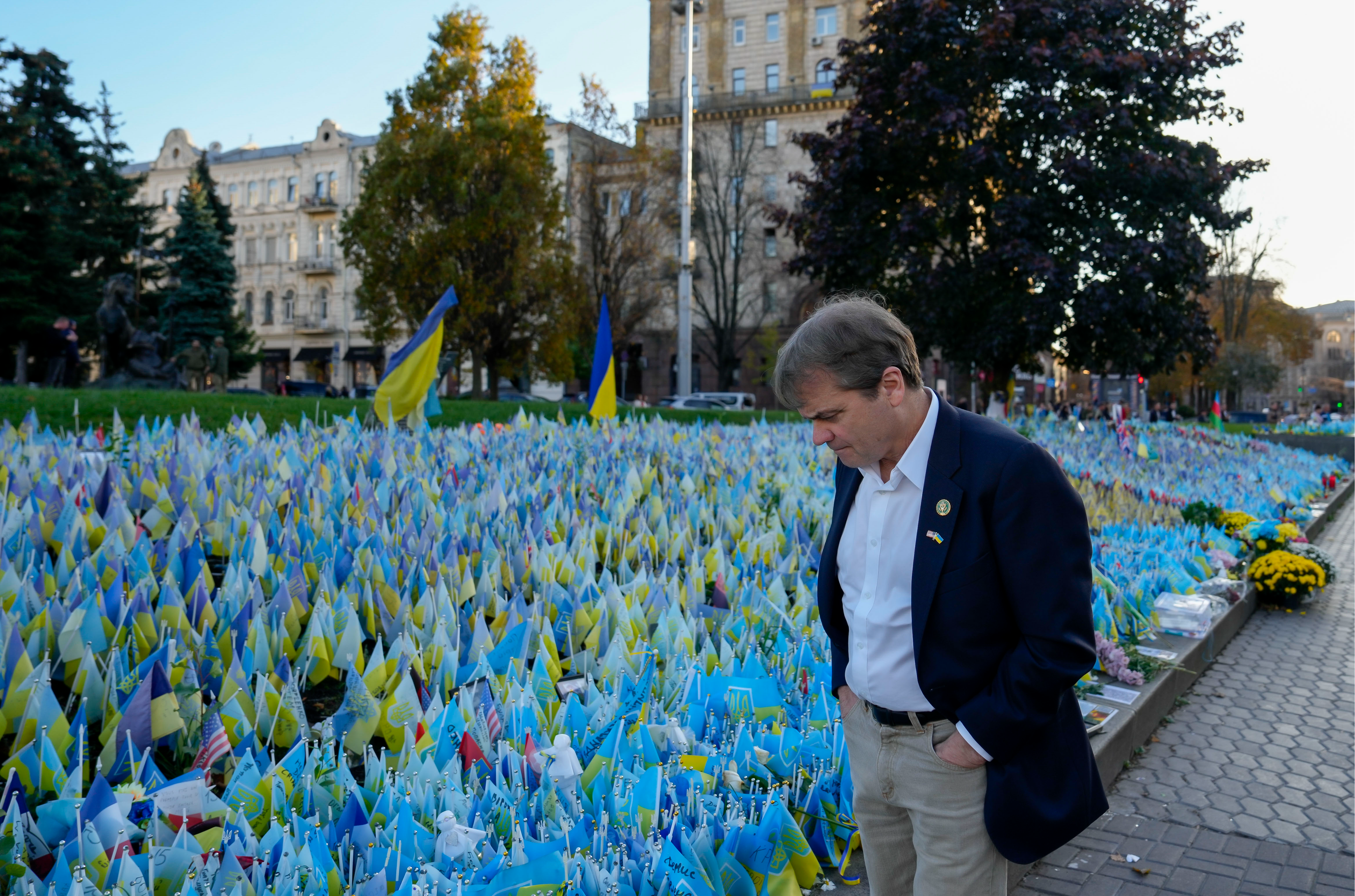 Rep. Quigley somberly looks at a field of small Ukrainian flags in Kyiv