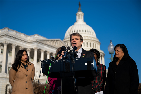 Quigley speaks at the PROTECT Immigration Act press conference, standing at a podium, looking angry and passionate.