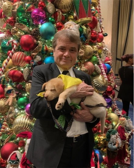 Quigley holding puppy at PAWS Chicago